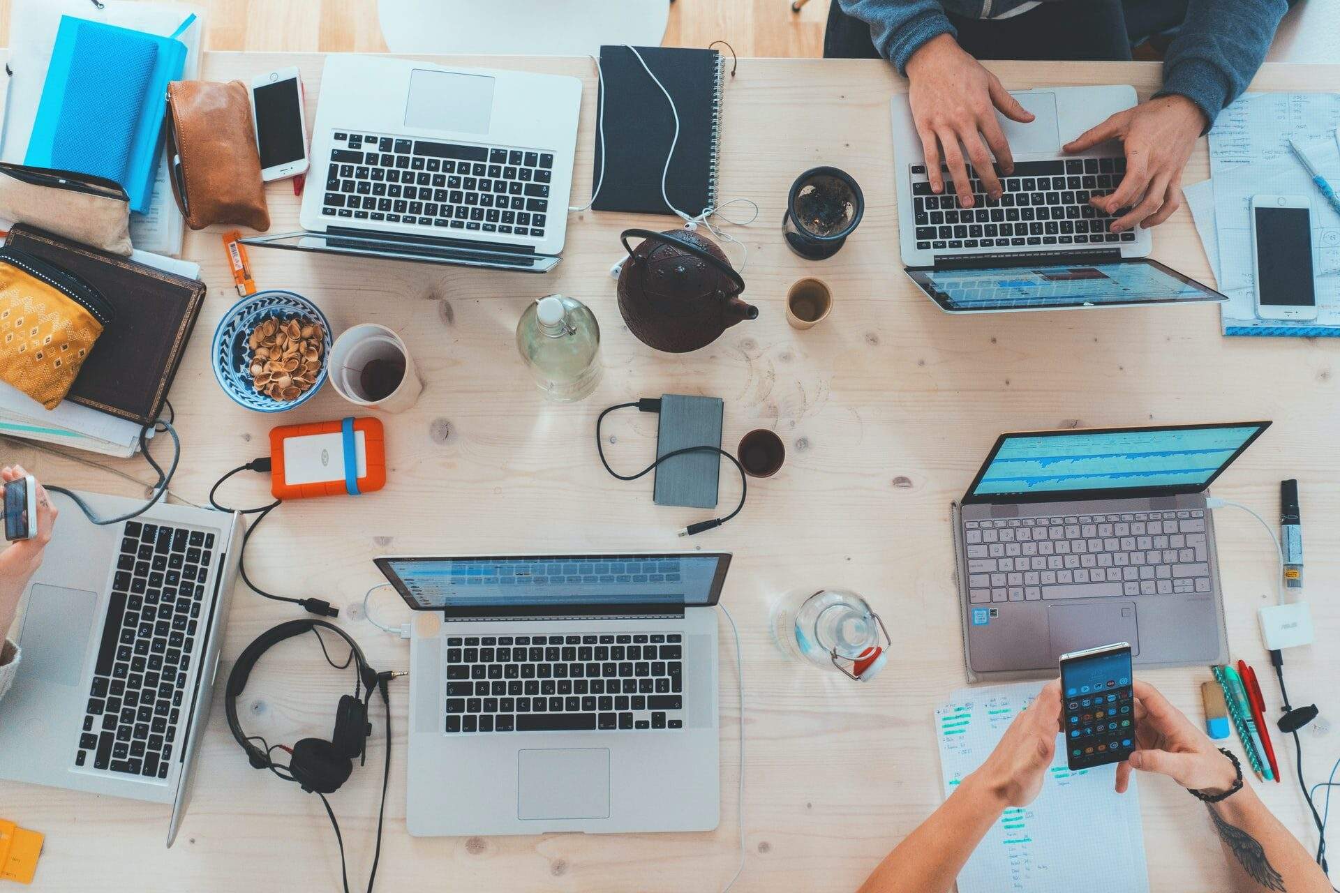 People working on laptops at a shared table