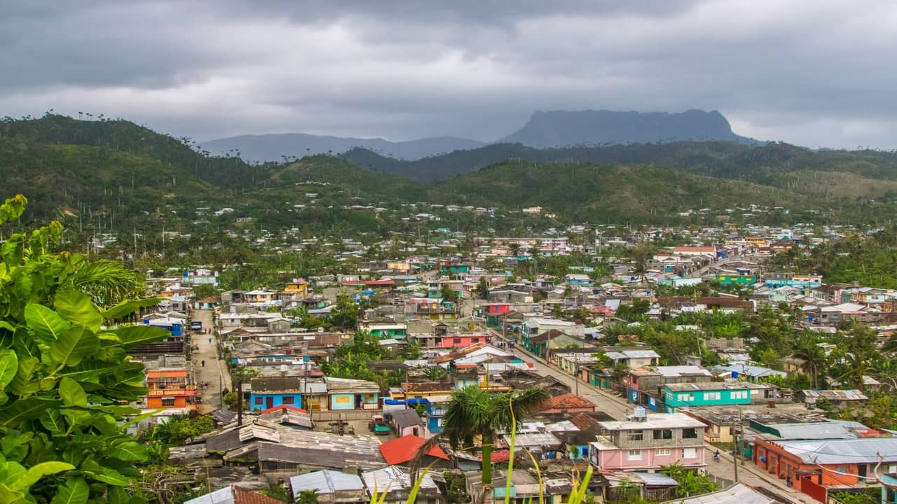 Colorful houses in a valley surrounded by mountains
