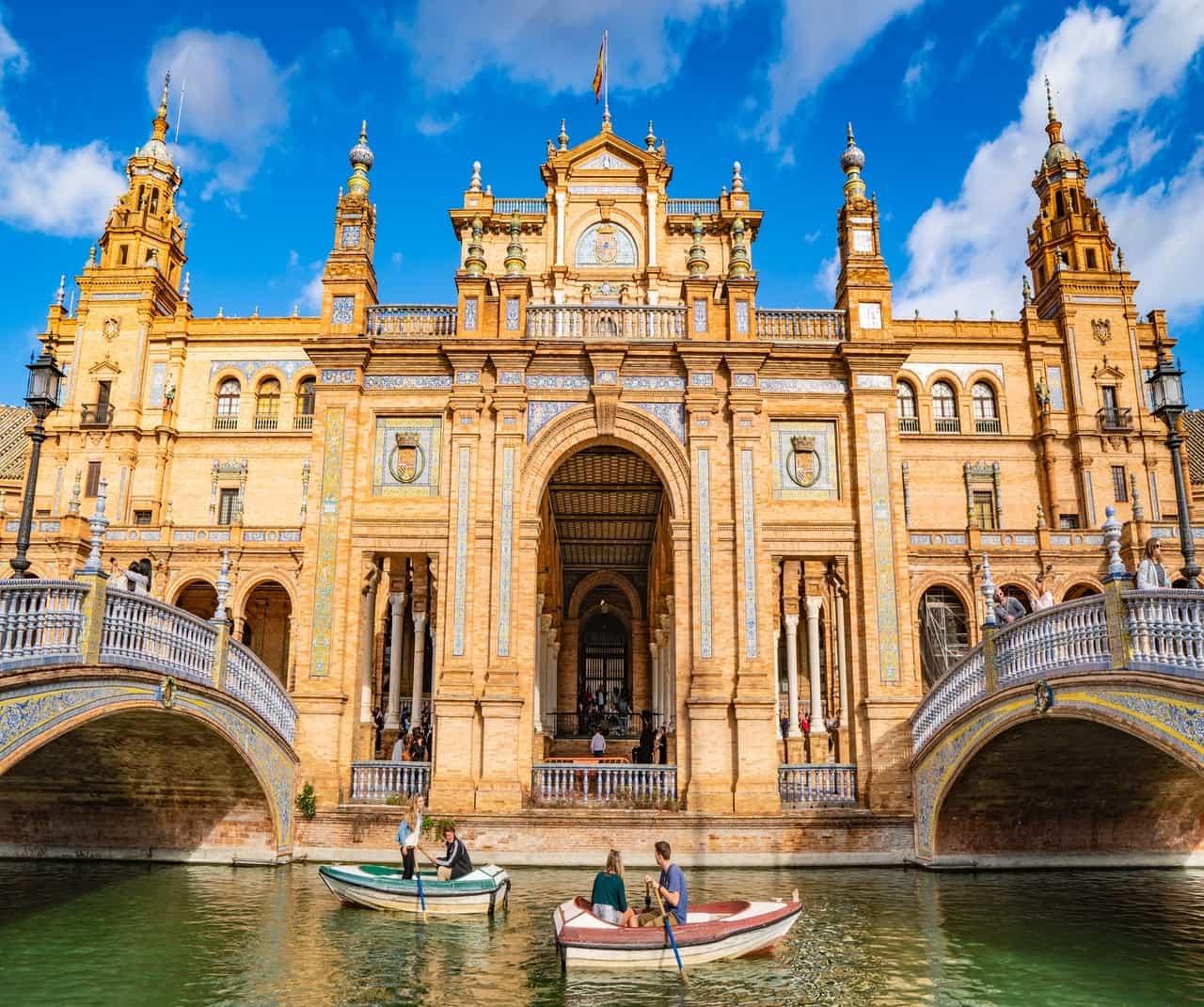 Boaters in front of large ornate building