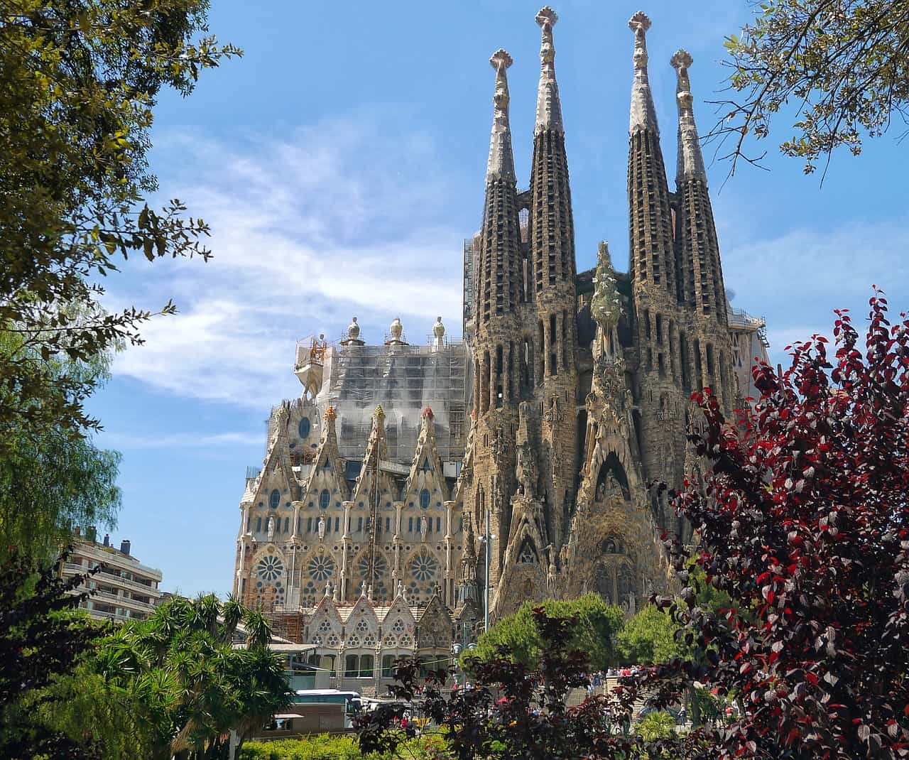 Sagrada Familia basilica surrounded by greenery and blue sky