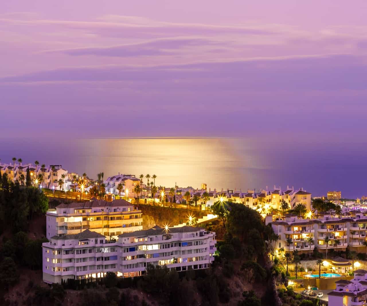 Night view of coastal city with illuminated buildings