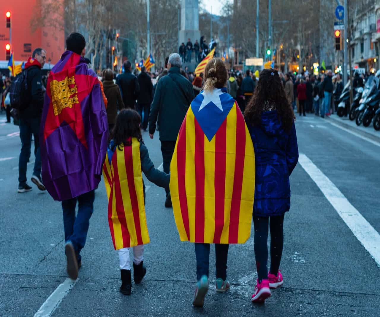 People wearing flags walking during a street protest
