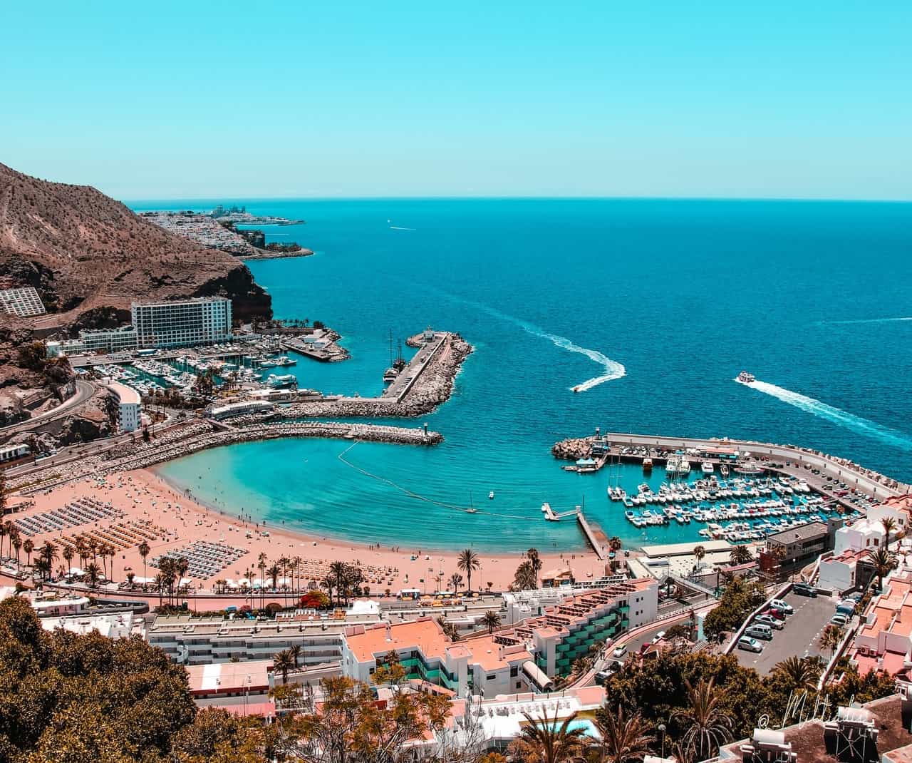 Aerial view of beach and marina with boats