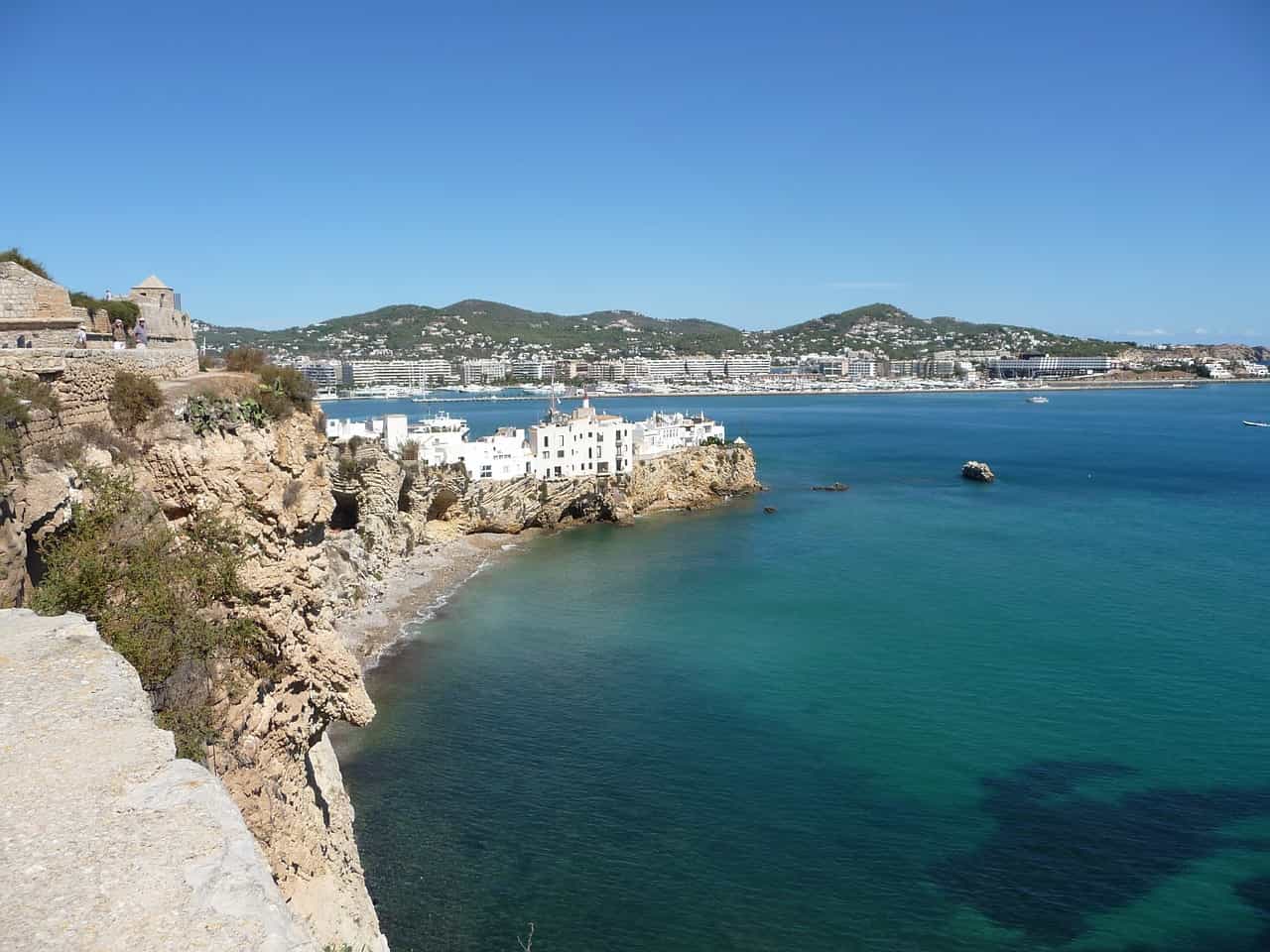 Cliffside view of white buildings and blue sea