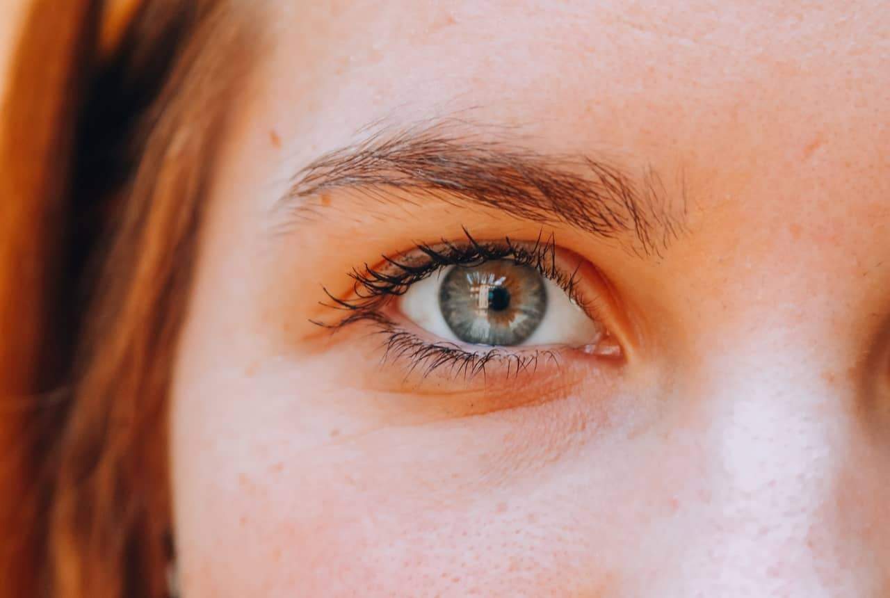 Close-up of a person's blue eye and eyebrow