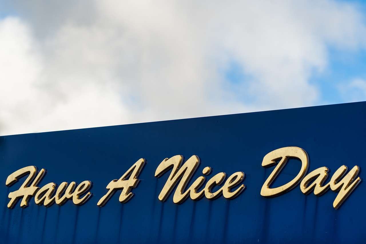 "Have A Nice Day" written on a blue sign