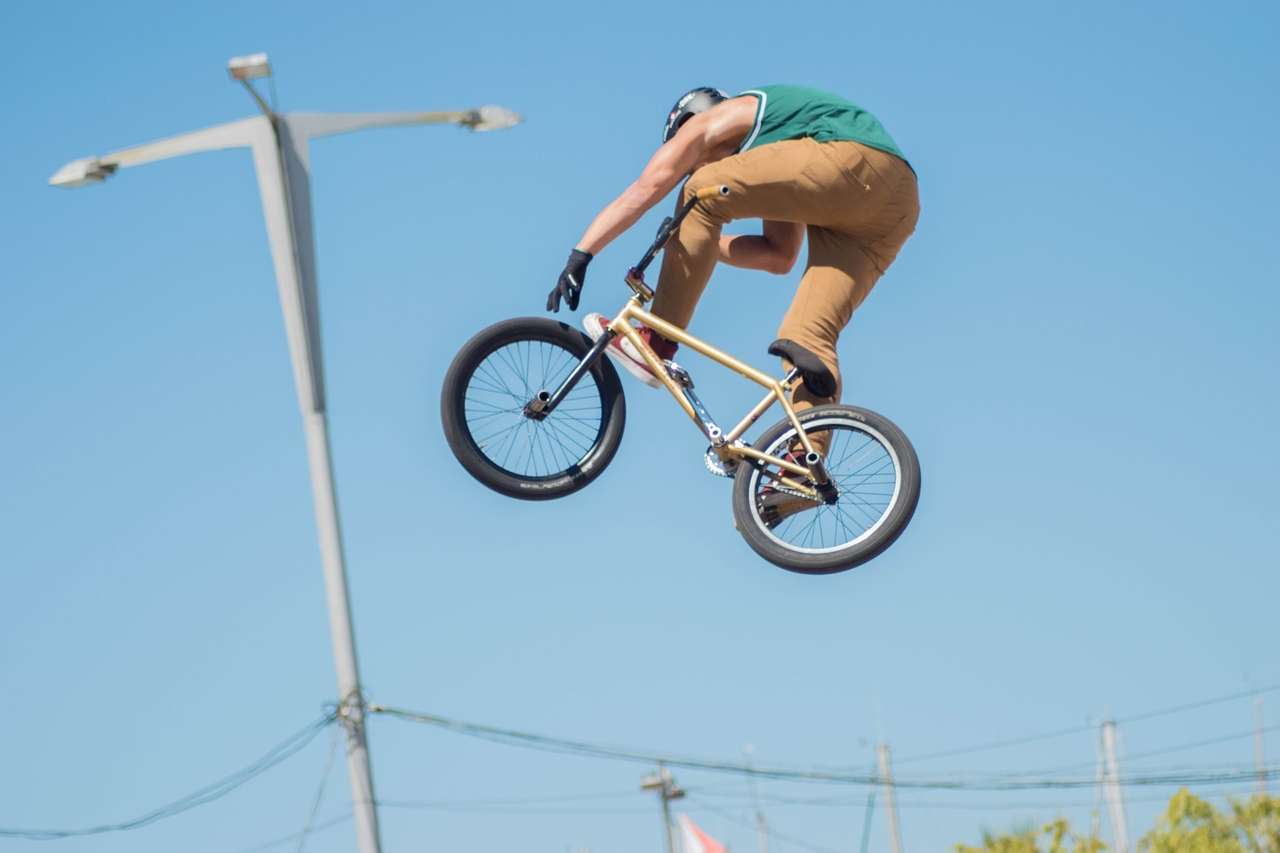 Person performing a high jump on a BMX bike
