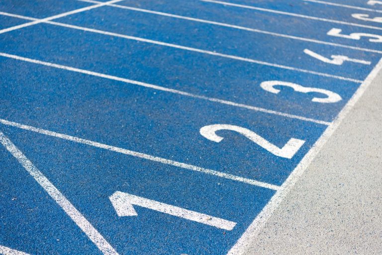 Close-up of blue race track with numbered lanes 1-6