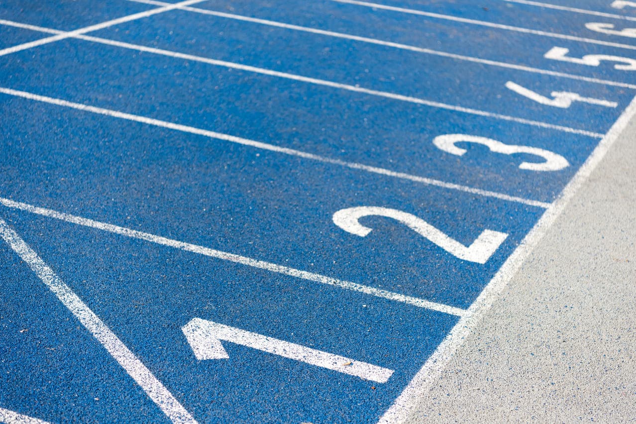 Close-up of blue race track with numbered lanes 1-6