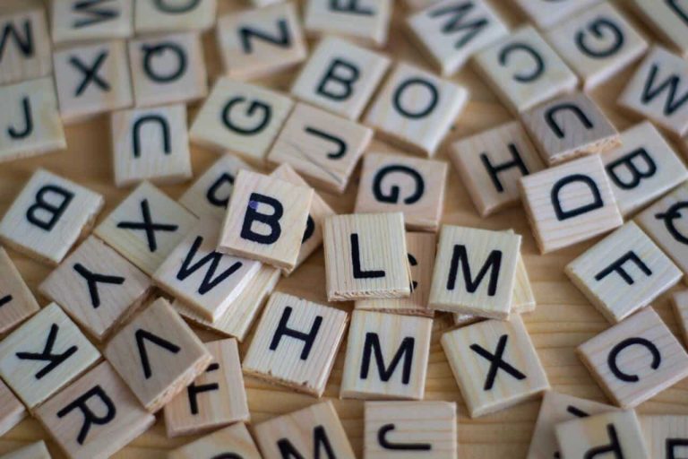 Scattered wooden letter tiles on a table
