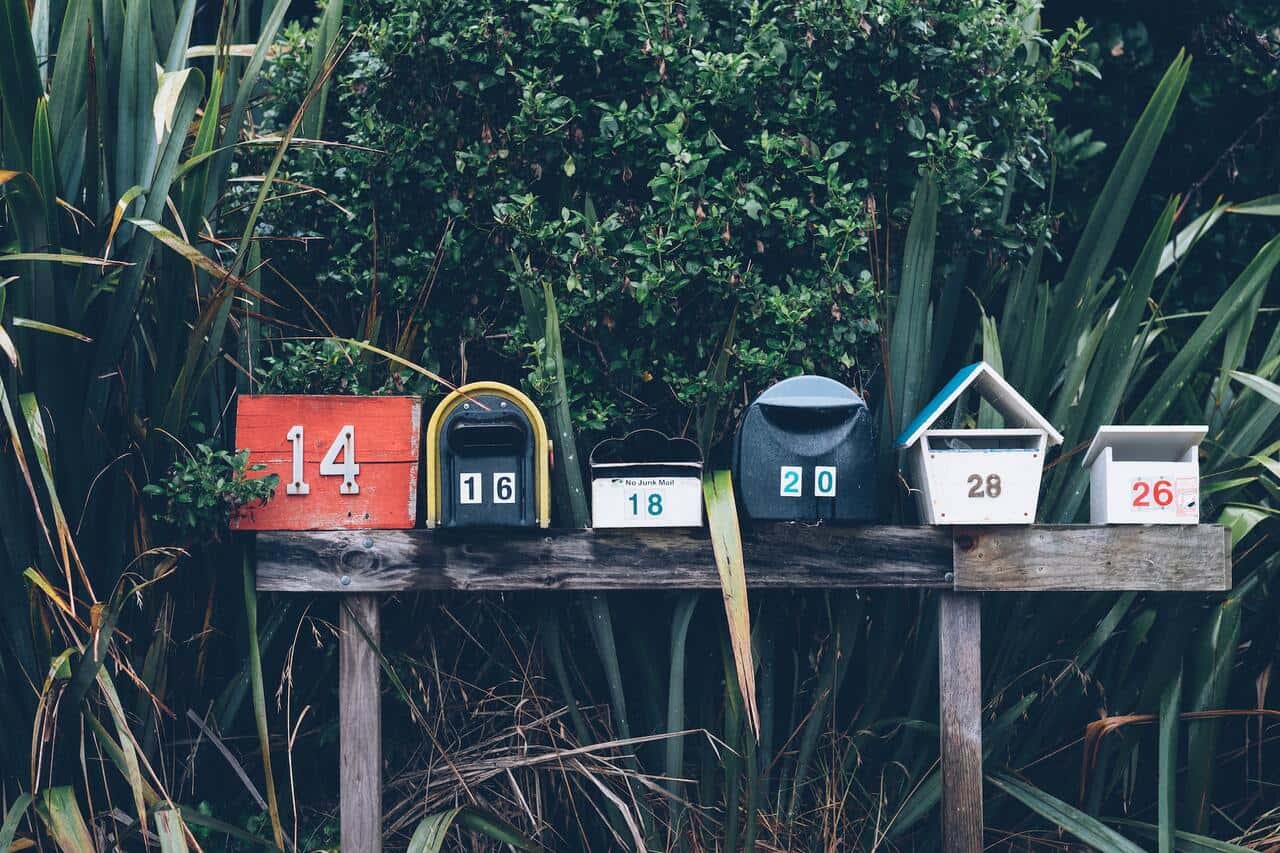 A row of colorful mailboxes with house numbers