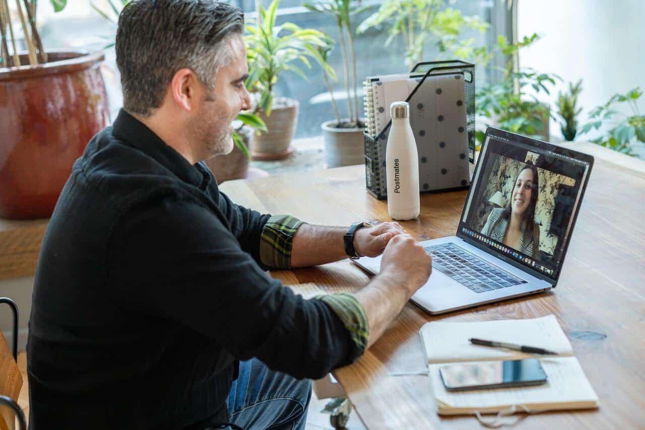 Person having a video call on laptop while working