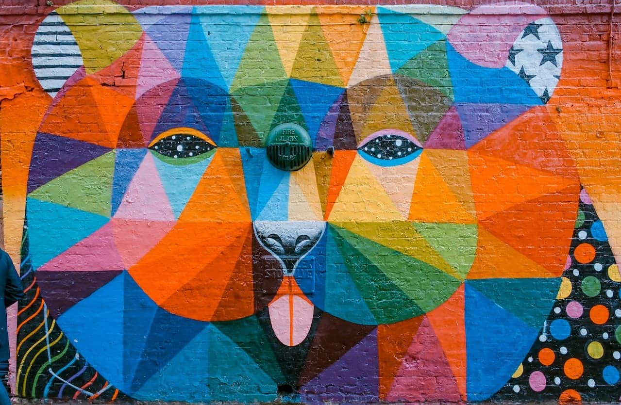 Colorful geometric mural of a bear on a wall