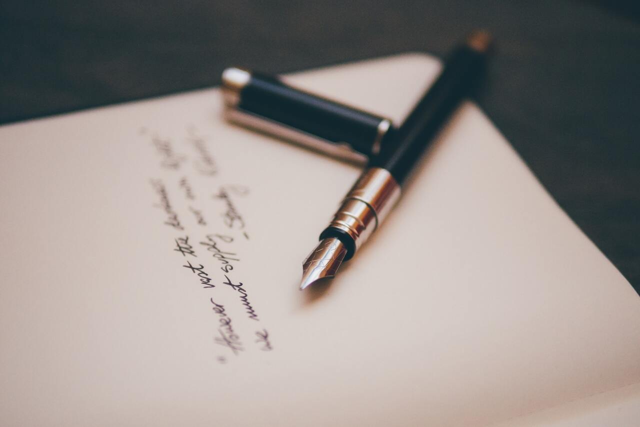 Fountain pen placed on an open notebook