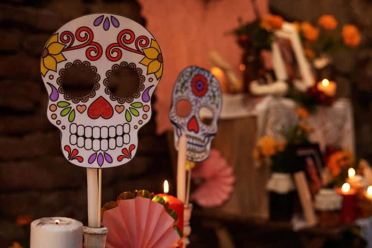 Colorful Day of the Dead skull masks at an altar