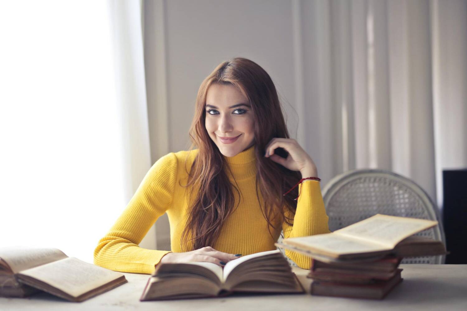 Woman sitting at desk with books