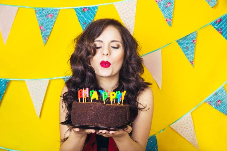 Woman blowing candles on a birthday cake