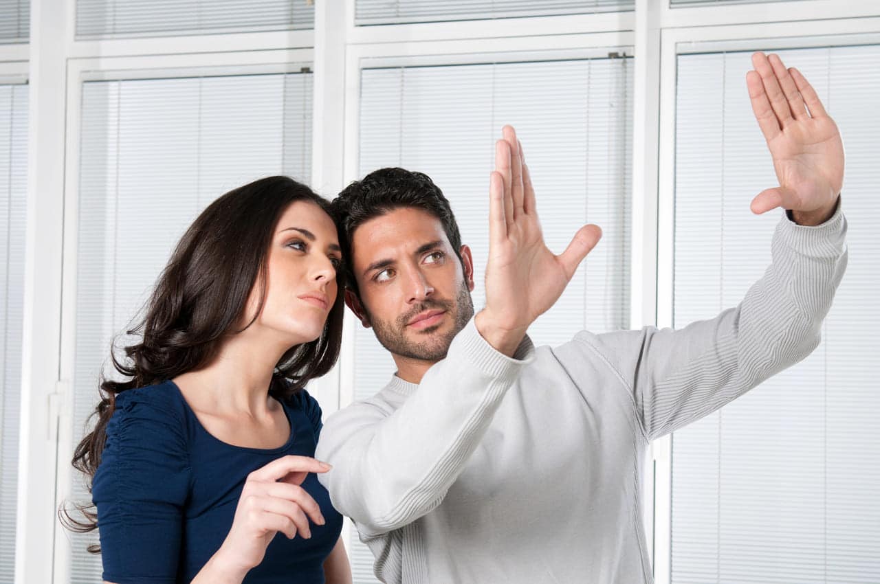 Man explaining a concept to a woman, gesturing with hands