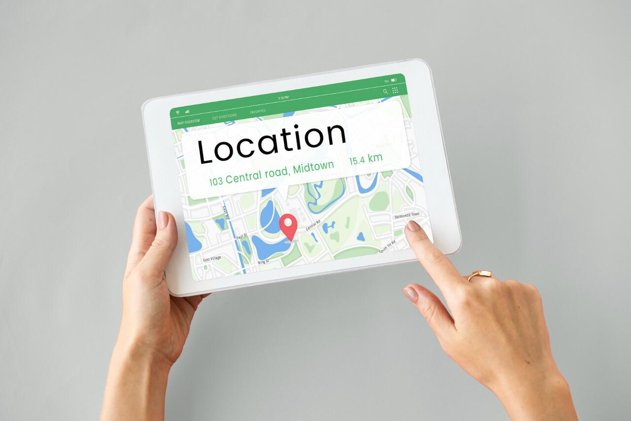 Person using a tablet displaying a location map