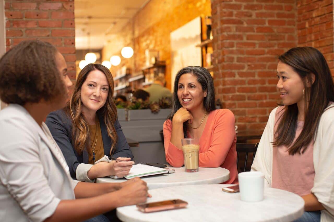 group of women having a discussion at a cafe
