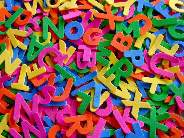 Colorful foam alphabet letters scattered on a surface