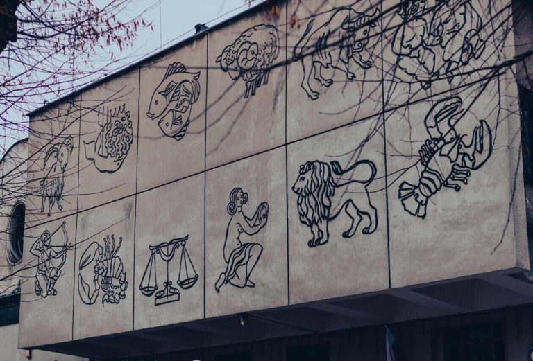 Zodiac symbols displayed on a building exterior wall