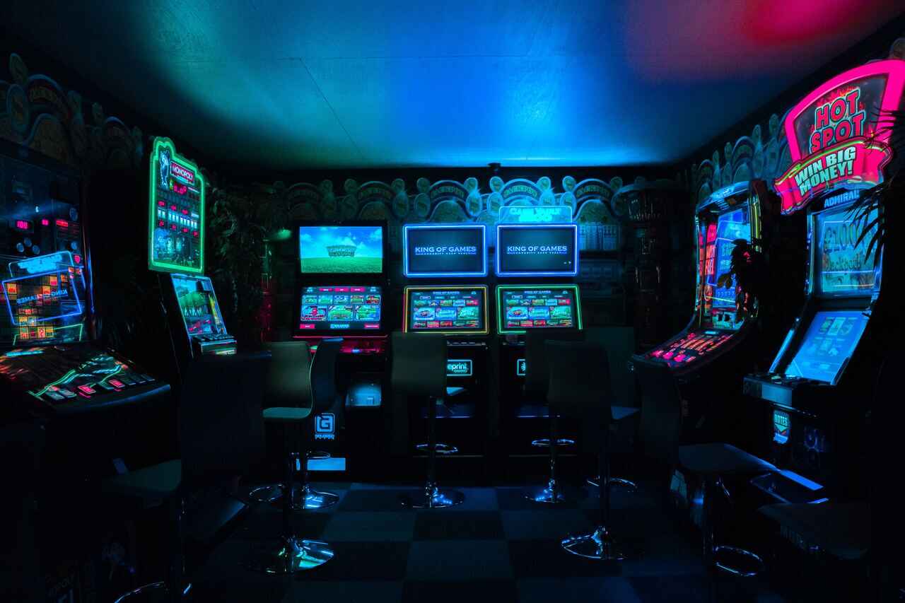 A dimly lit arcade room with various gaming machines.