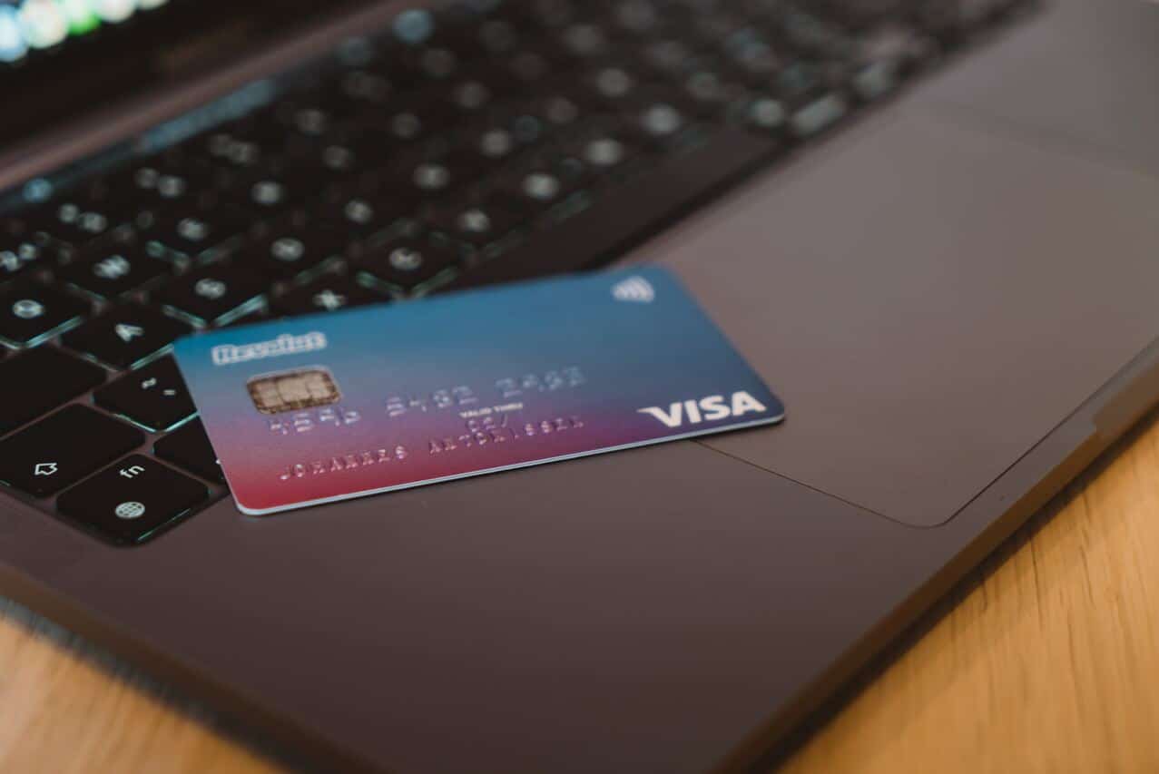 Visa credit card placed on a laptop keyboard