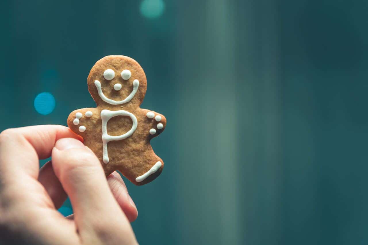Hand holding gingerbread cookie with icing letter P
