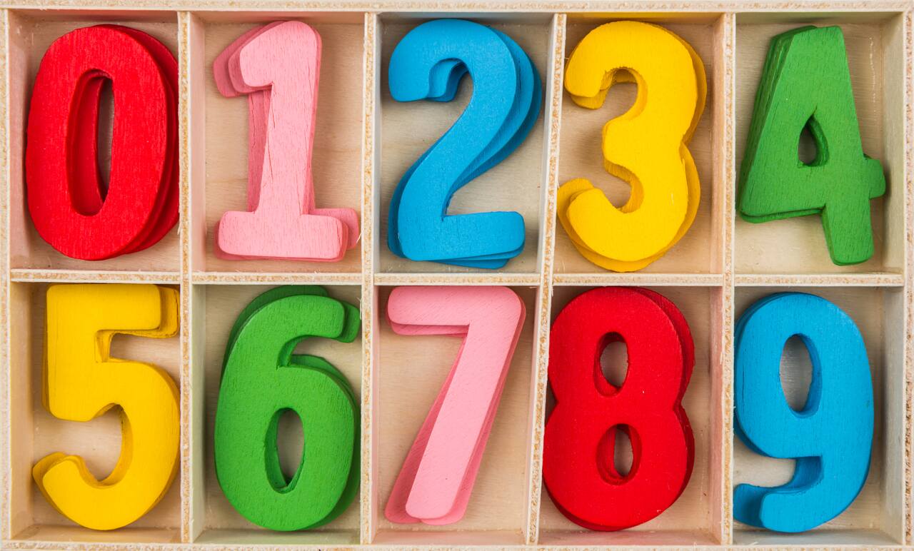 Colorful wooden numbers 0 to 9 in a box