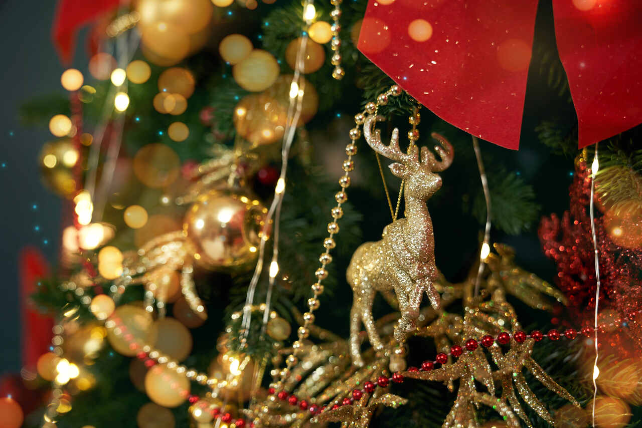 Christmas tree decorated with golden reindeer and ornaments