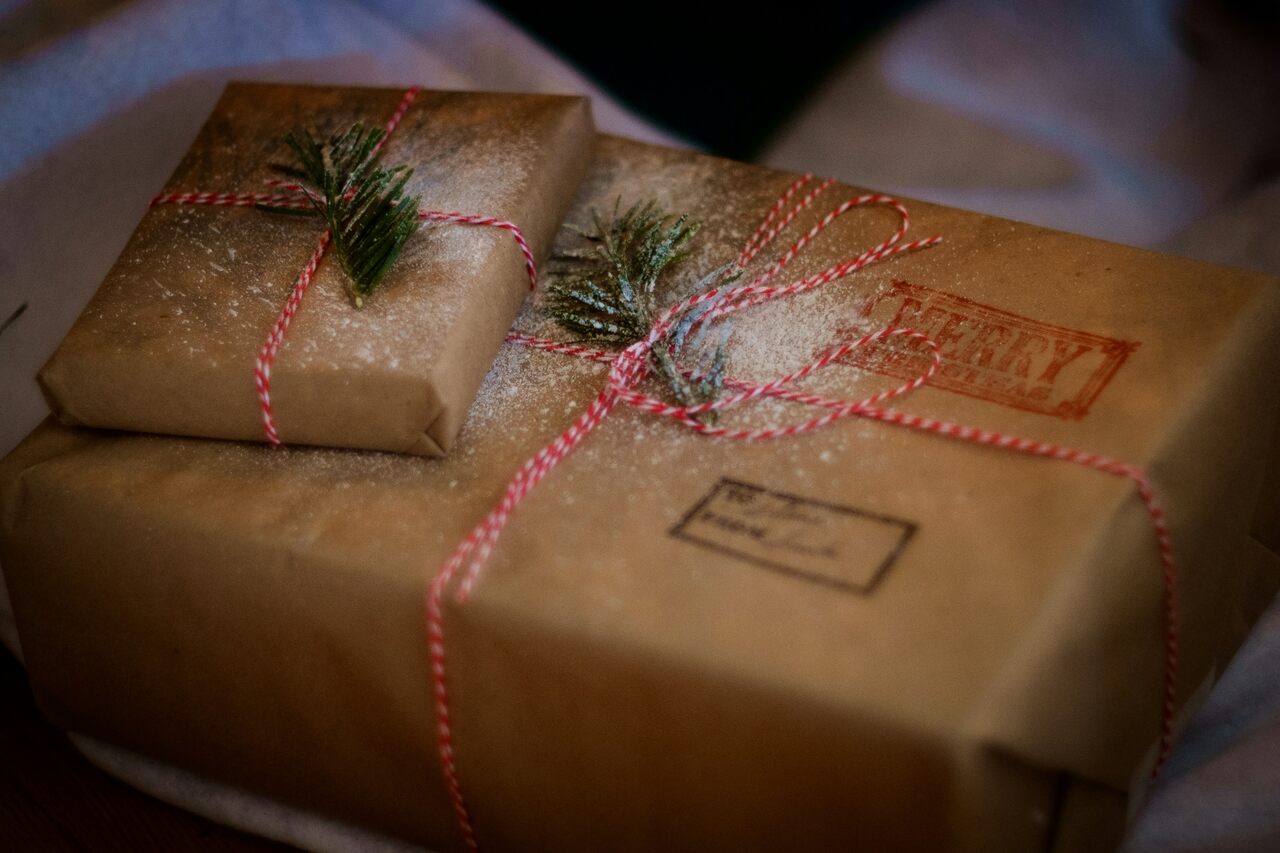 Gift boxes wrapped in brown paper with pine branches