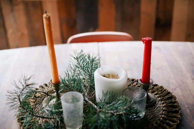 Candle arrangement with pine branches on a wooden table