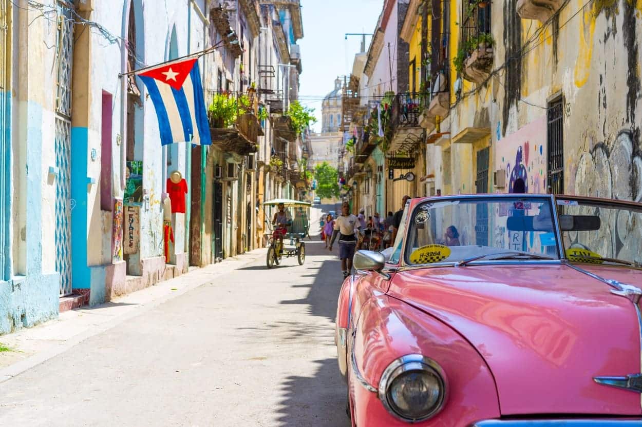 Street in Cuba with a vintage pink convertible