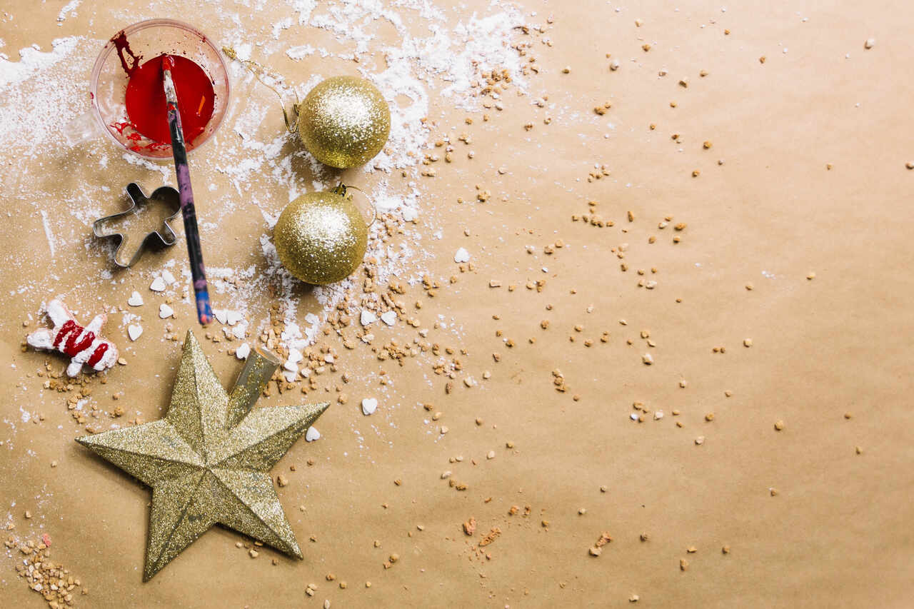 Craft supplies including glitter ornaments and paint on a table