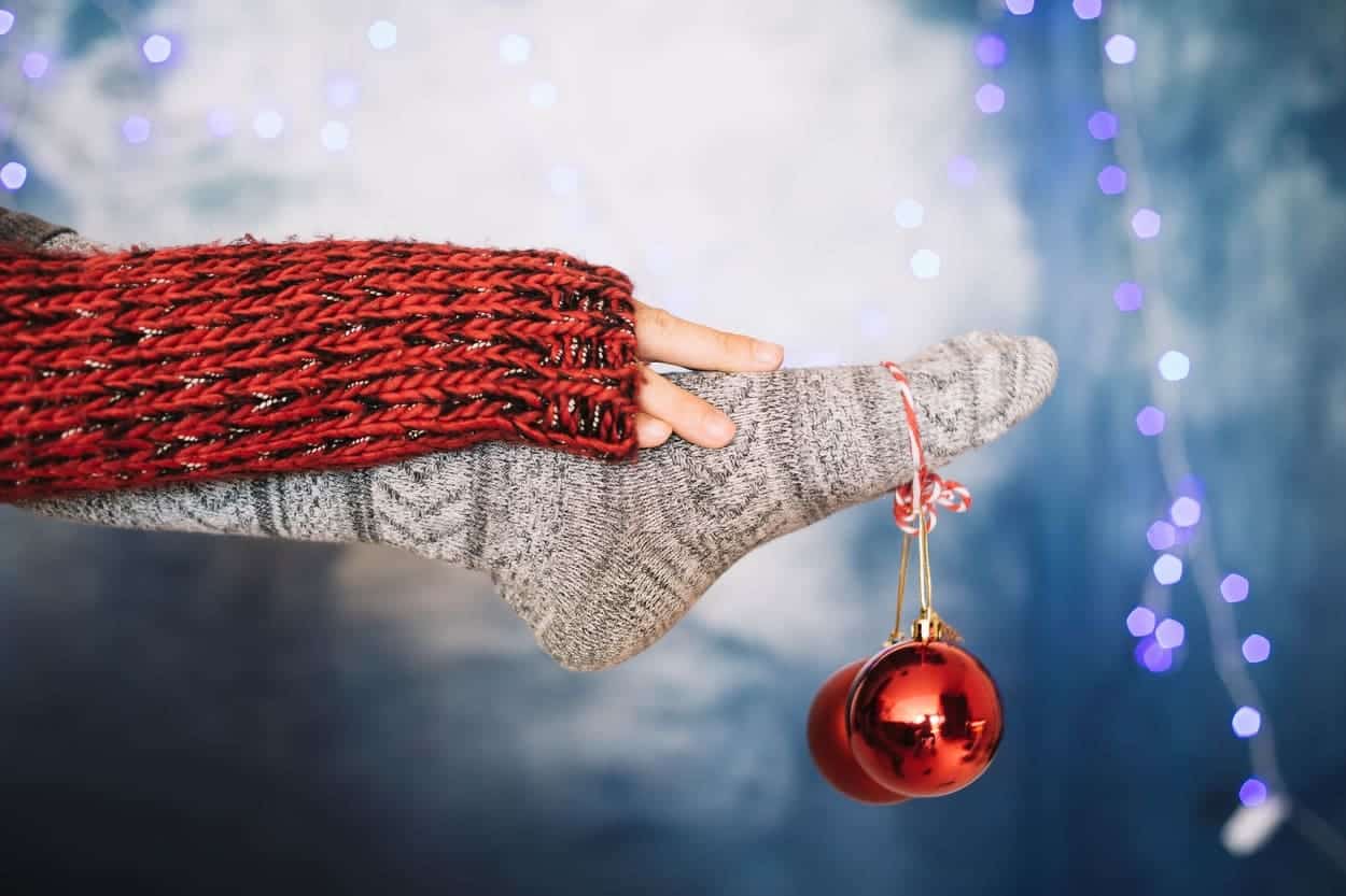 Cozy sock and red Christmas ornament hanging