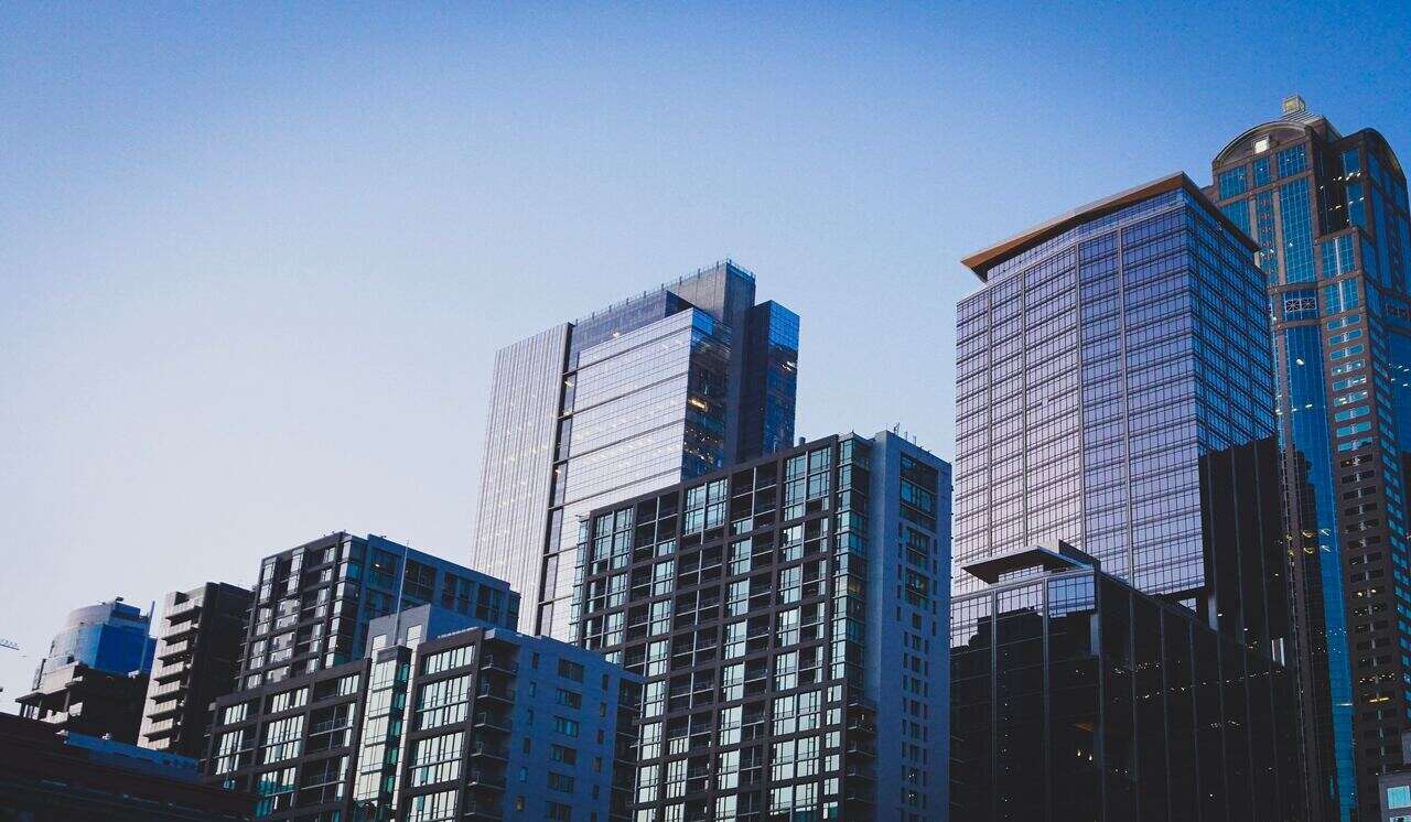 This image shows modern high-rise buildings against a clear blue sky