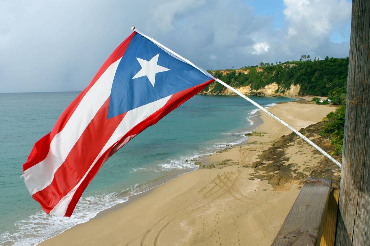 Puerto Rican flag waving on a beach