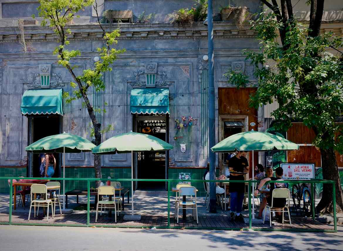 Outdoor cafe with green umbrellas and seating