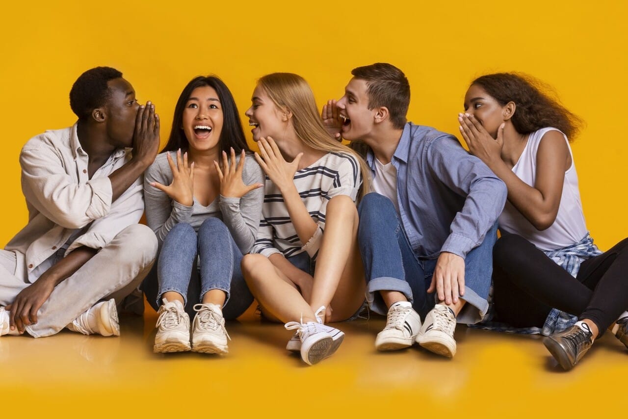 Group of friends whispering and laughing together