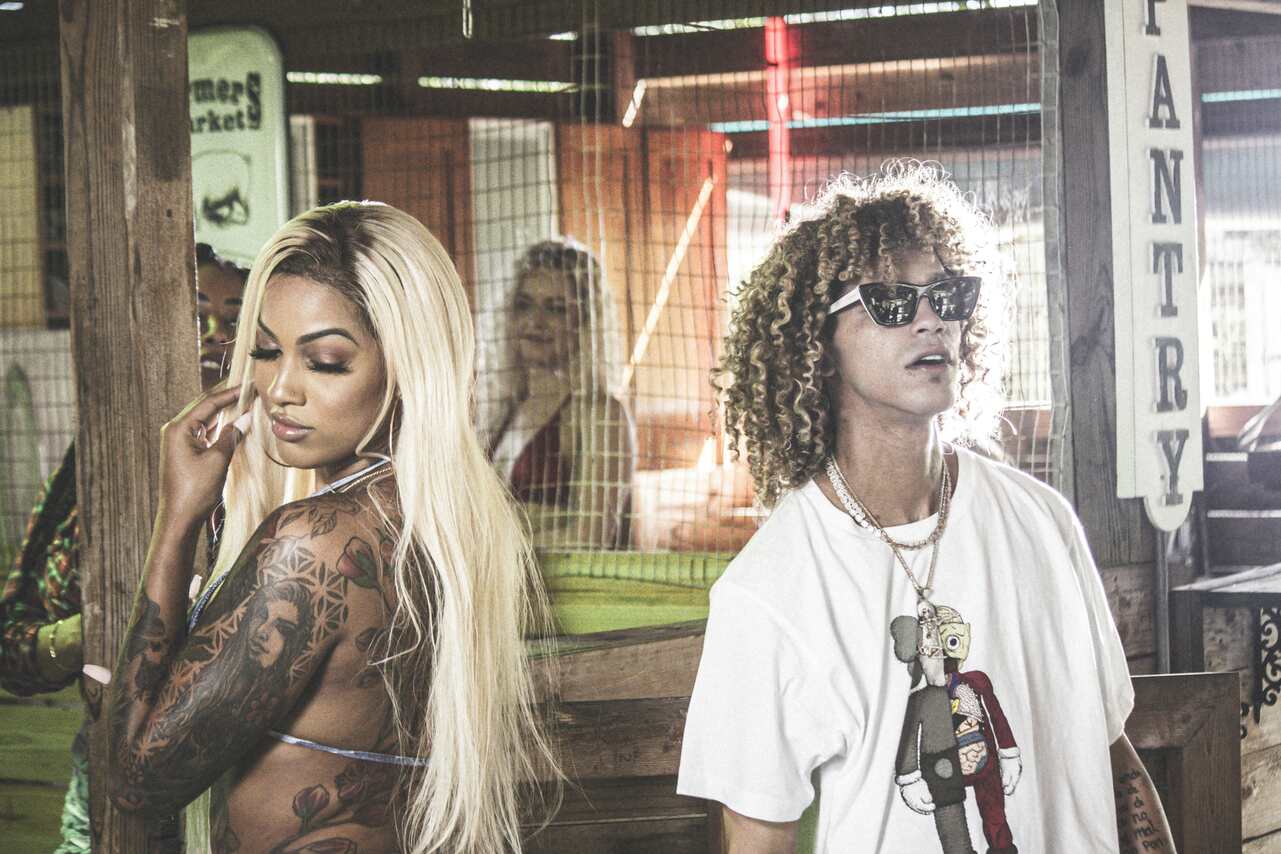 Tattooed woman and man with curly hair