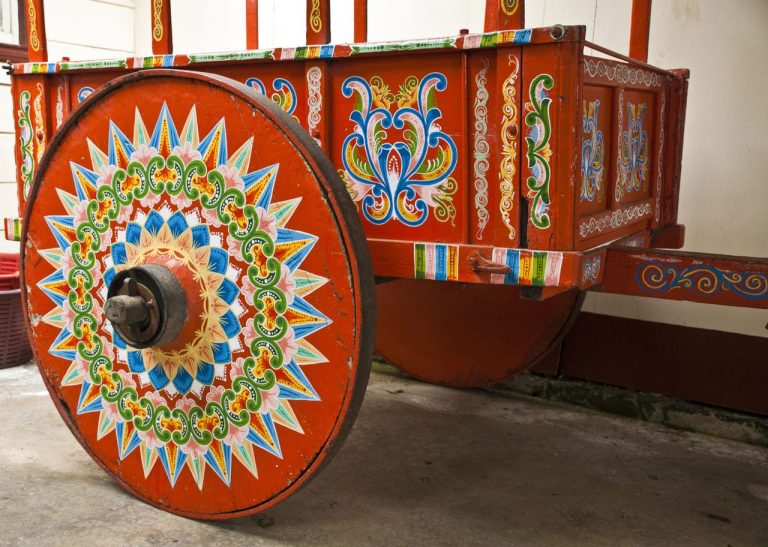 Colorfully painted wooden cart with intricate patterns on its wheel