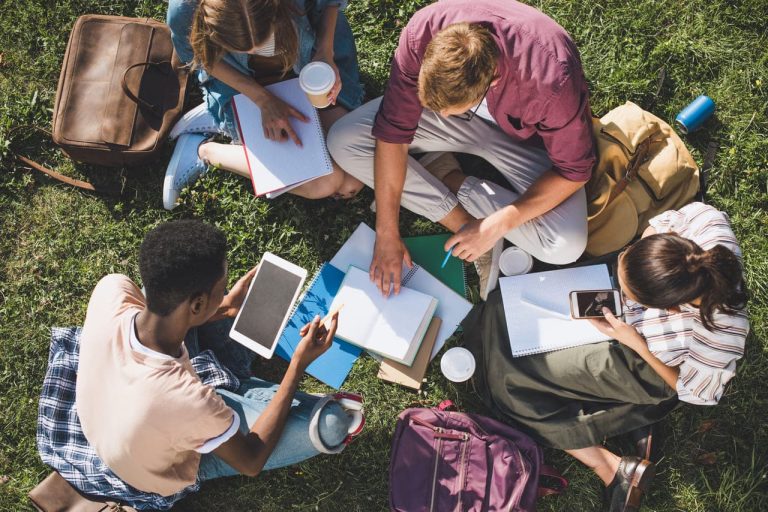 A group of students studying together outdoors