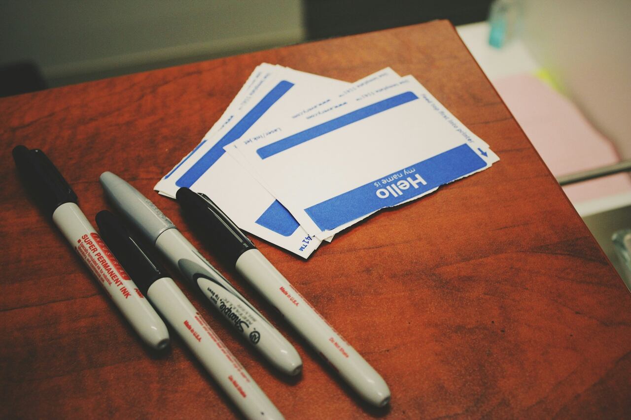 Blank name tags and markers on a desk.